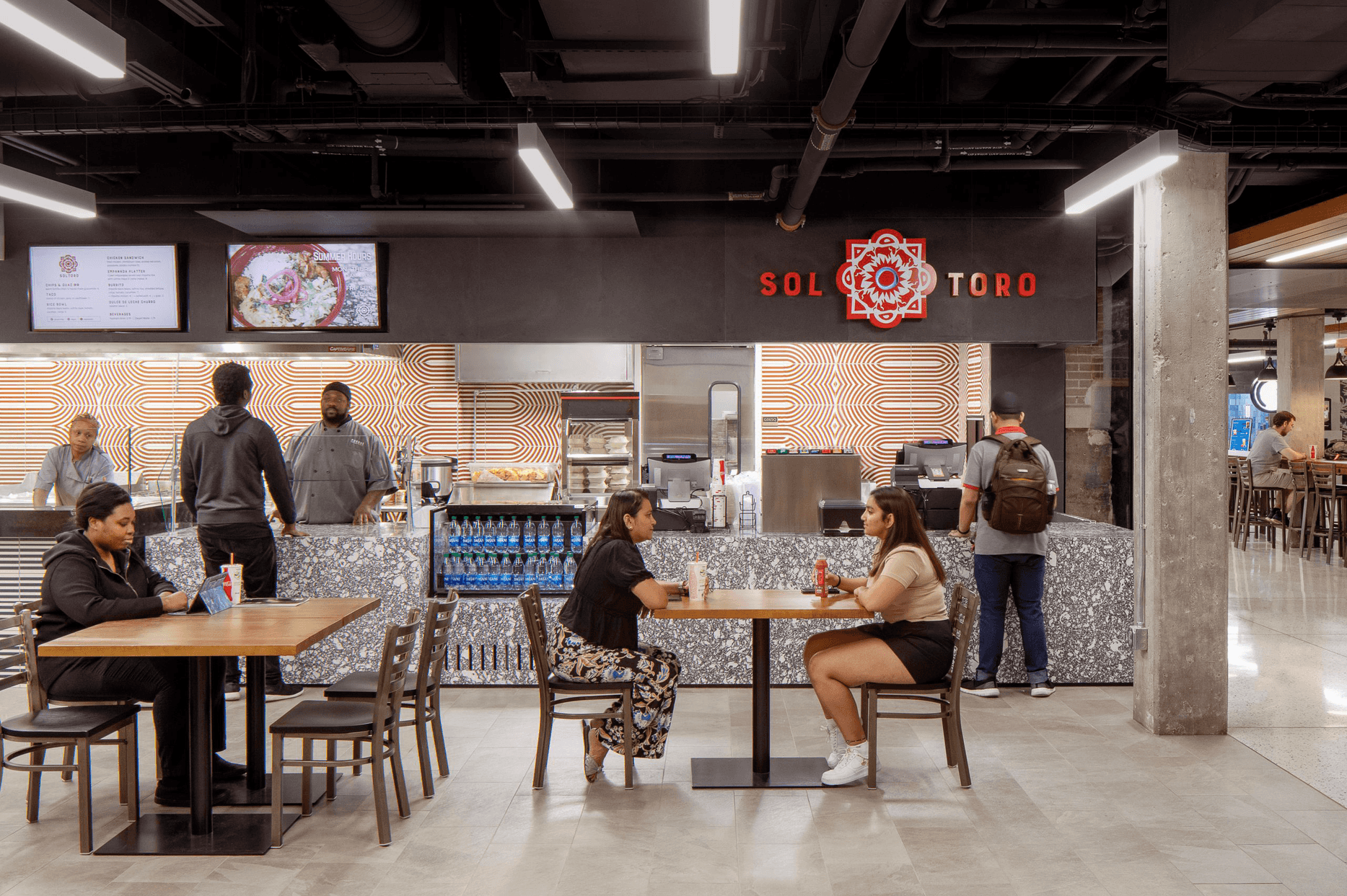 Students eating together inside Airfield Memorial Union
